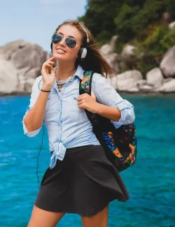 beautiful-hipster-woman-traveling-around-world-with-backpack-smiling-happy-positive-listening-music-headphones-blue-tropical-ocean-background-sunglasses-sexy-summer-vacation_285396-6054.jpg